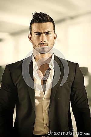 Handsome young businessman in office building, standing Stock Photo