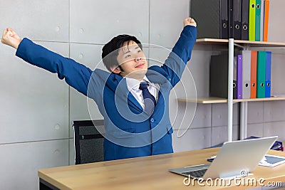 Handsome young businessman is stretching his back and raise up h Stock Photo