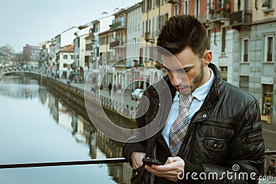 Handsome young businessman texting Stock Photo