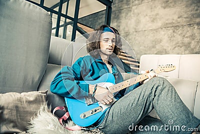 Handsome young creator with wavy hair wearing bandana Stock Photo