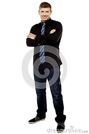 Handsome young male executive with folded arms Stock Photo