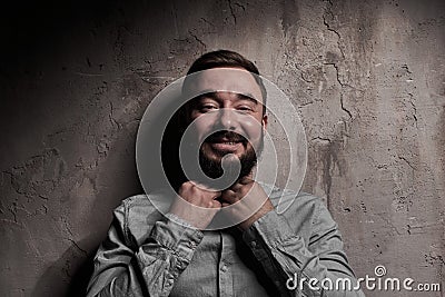 A handsome young man with a beard. The emotions of a man. Depression or hopelessness. Dramatic emotional portrait of a Stock Photo