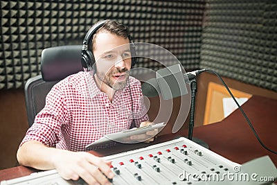 Radio jockey hosting show live on radio Stock Photo
