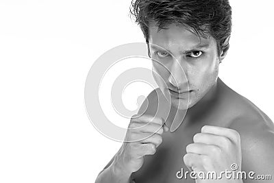 Handsome young man is boxer or fighter guy. Young guy looks confident, determined. He get ready to fight and win of business. Cool Stock Photo