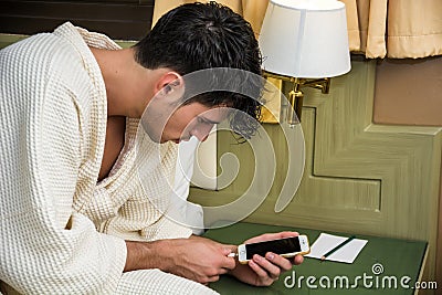 Handsome Young Man Connecting a Phone to a Charger Stock Photo