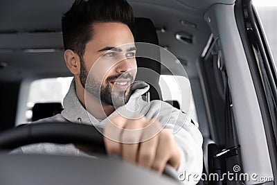 Handsome young man driving his car Stock Photo