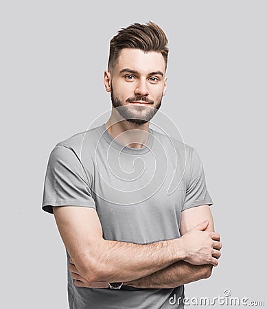 Handsome young man with folded arms isolated portrait. Joyful cheerful smiling men with crossed hands studio shot Stock Photo
