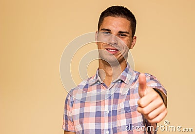 Handsome young man gesturing Thumbs Up Stock Photo