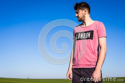 Handsome young man on green filed Stock Photo