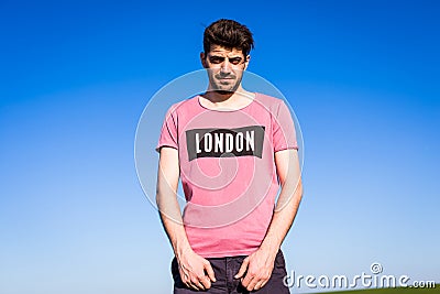 Handsome young man on green filed Stock Photo