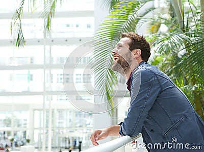 Handsome young man leaning inside bright building Stock Photo
