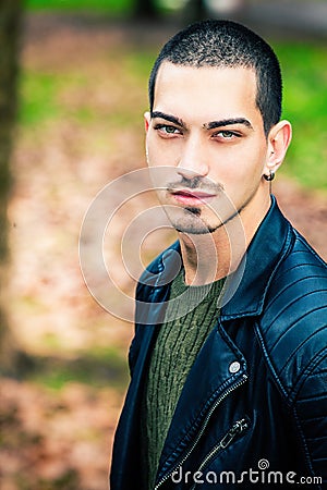 Handsome young man outdoors, short hair style Stock Photo