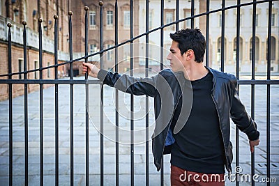 Handsome young man outside historical building in European city Stock Photo