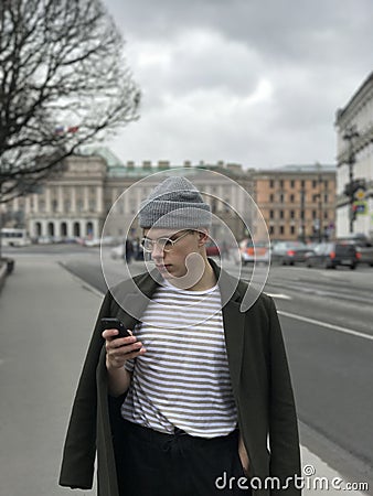 Handsome young man with phone in St. Petersburg at the St. Isaac`s Cathedral Stock Photo