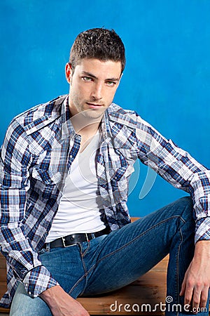 Handsome young man with plaid shirt on blue Stock Photo