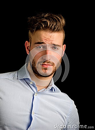 Handsome young man portrait with doubtful, unsure expression Stock Photo