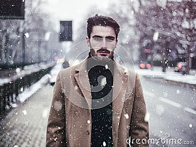Young man in snowy city Stock Photo