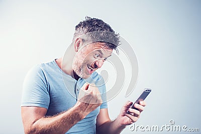 Handsome young man using mobile phone feel happy Stock Photo