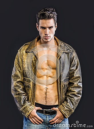 Handsome young man wearing leather jacket on naked Stock Photo