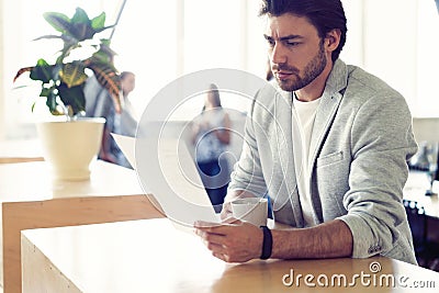 Handsome young smiling businessman working with documents. Stock Photo