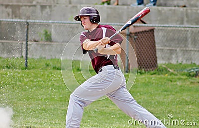 Handsome Young Teen Baseball Player Swinging the Bat Stock Photo