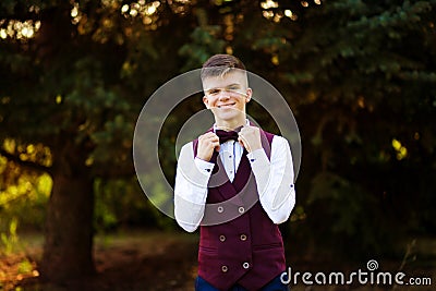 Handsome young waiter in red uniform look at camera. Employee concept Stock Photo