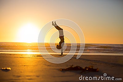 Handstand by the beach Stock Photo