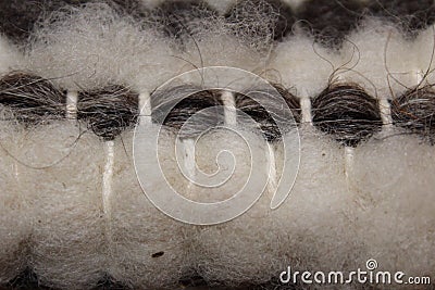 Handwoven wool rug on weaving loom Stock Photo