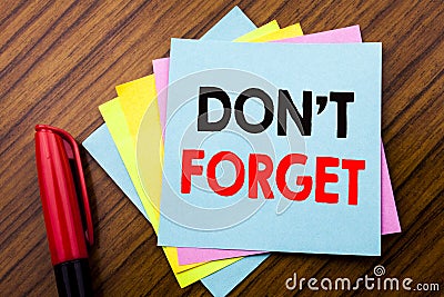 Handwriting Announcement text Do Not Forget. Concept for Don t memory Remider Written on sticky stick note paper with wooden back Stock Photo