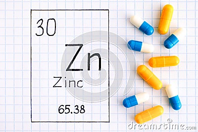 Handwriting chemical element Zinc Zn with pills Stock Photo