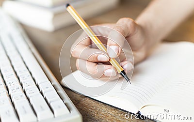 Handwriting, female hand writes with a pen in a diary notebook. Education . Stock Photo