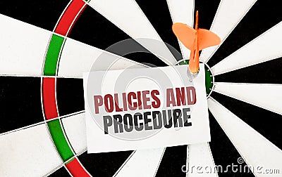 Handwriting POLICIES AND PROCEDURE on notepaper with dart arrow and dart board Stock Photo