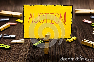 Handwriting text Auction. Concept meaning Public sale Goods or Property sold to highest bidder Purchase Clothespin Stock Photo