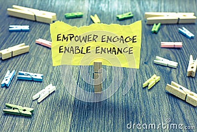 Handwriting text Empower Engage Enable Enhance. Concept meaning Empowerment Leadership Motivation Engagement Paperclip hold writte Stock Photo