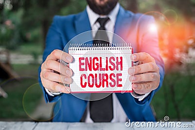 Handwriting text English Course. Concept meaning courses cover all levels of speaking and writing in english Man holds empty paper Stock Photo