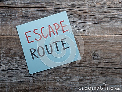Handwriting text writing Escape Route. Plain note paper on the top of wooden table desk Stock Photo