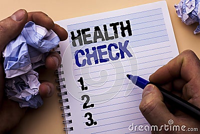 Handwriting text Health Check. Concept meaning Medical Examination Diagnosis Tests to prevent diseases written by Man on Notebook Stock Photo