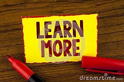 Handwriting text Learn More. Concept meaning Study harder Develop new skills abilities Get extra education written on Yellow Stick Stock Photo