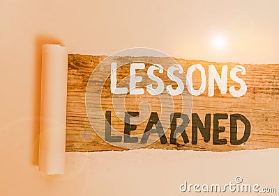 Handwriting text Lessons Learned. Concept meaning the knowledge or understanding gained by experience Cardboard which is Stock Photo