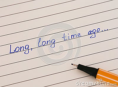 Handwriting text Long, Long Time Ago... on lined paper with pen Stock Photo