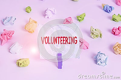 Handwriting text Volunteering. Concept meaning Provide services for no financial gain Willingly Oblige Colored crumpled Stock Photo