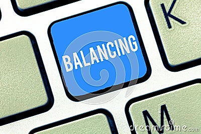 Handwriting text writing Balancing. Concept meaning put something in a steady position so that it does not fall Keyboard Stock Photo