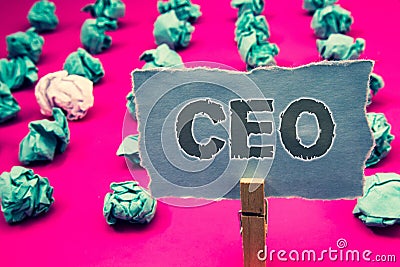 Handwriting text writing Ceo. Concept meaning Chief Executive Officer Head Boss Chairperson Chairman Controller Clothespin holding Stock Photo