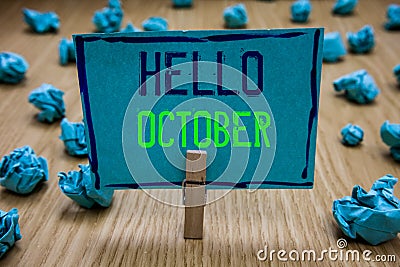 Handwriting text writing Hello October. Concept meaning Last Quarter Tenth Month 30days Season Greeting Clothespin holding blue pa Stock Photo