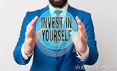 Handwriting text writing Invest In Yourself. Concept meaning learn new things or materials thus making your lot better Man in Stock Photo