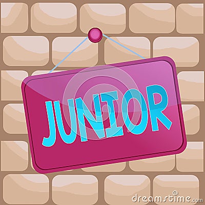 Handwriting text writing Junior. Concept meaning erson who is a specified number of years younger than someone else Colored memo Stock Photo