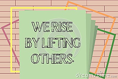 Handwriting text writing We Rise By Lifting Others.. Concept meaning Team Spirit we feel Abundant with possibility Stock Photo