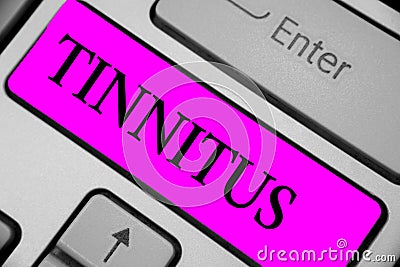 Handwriting text writing Tinnitus. Concept meaning A ringing or music and similar sensation of sound in ears Keyboard purple key I Stock Photo