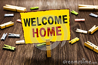 Handwriting text writing Welcome Home. Concept meaning Expression Greetings New Owners Domicile Doormat Entry Clothespin holding y Stock Photo