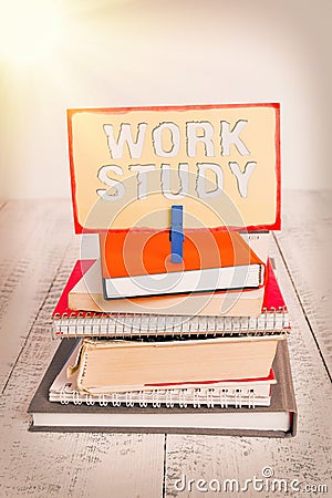 Handwriting text writing Work Study. Concept meaning college program that enables students to work parttime pile stacked books Stock Photo